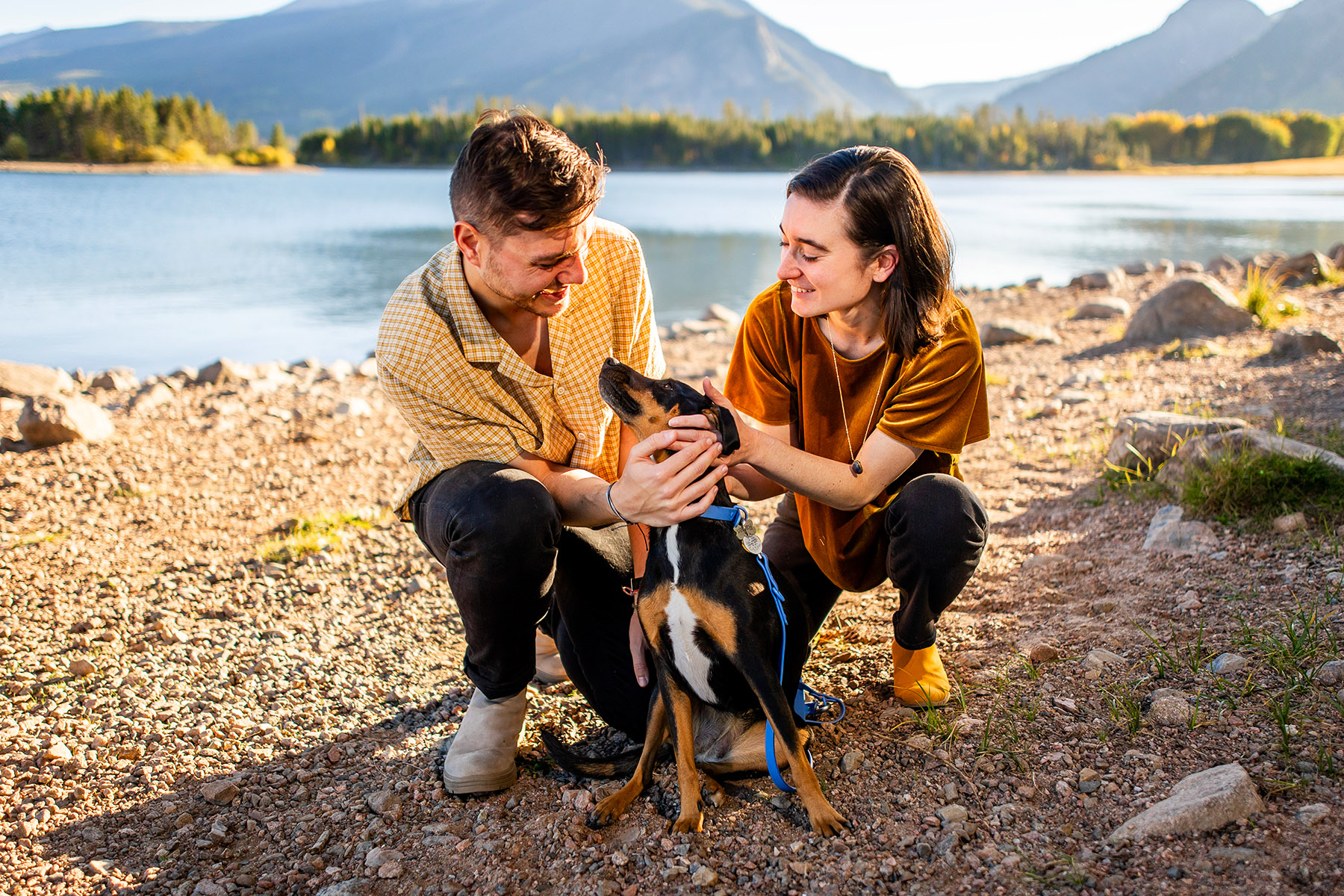 Engaged couple with their dog at Dillon Reservoir near Breckenridge Colorado in the fall